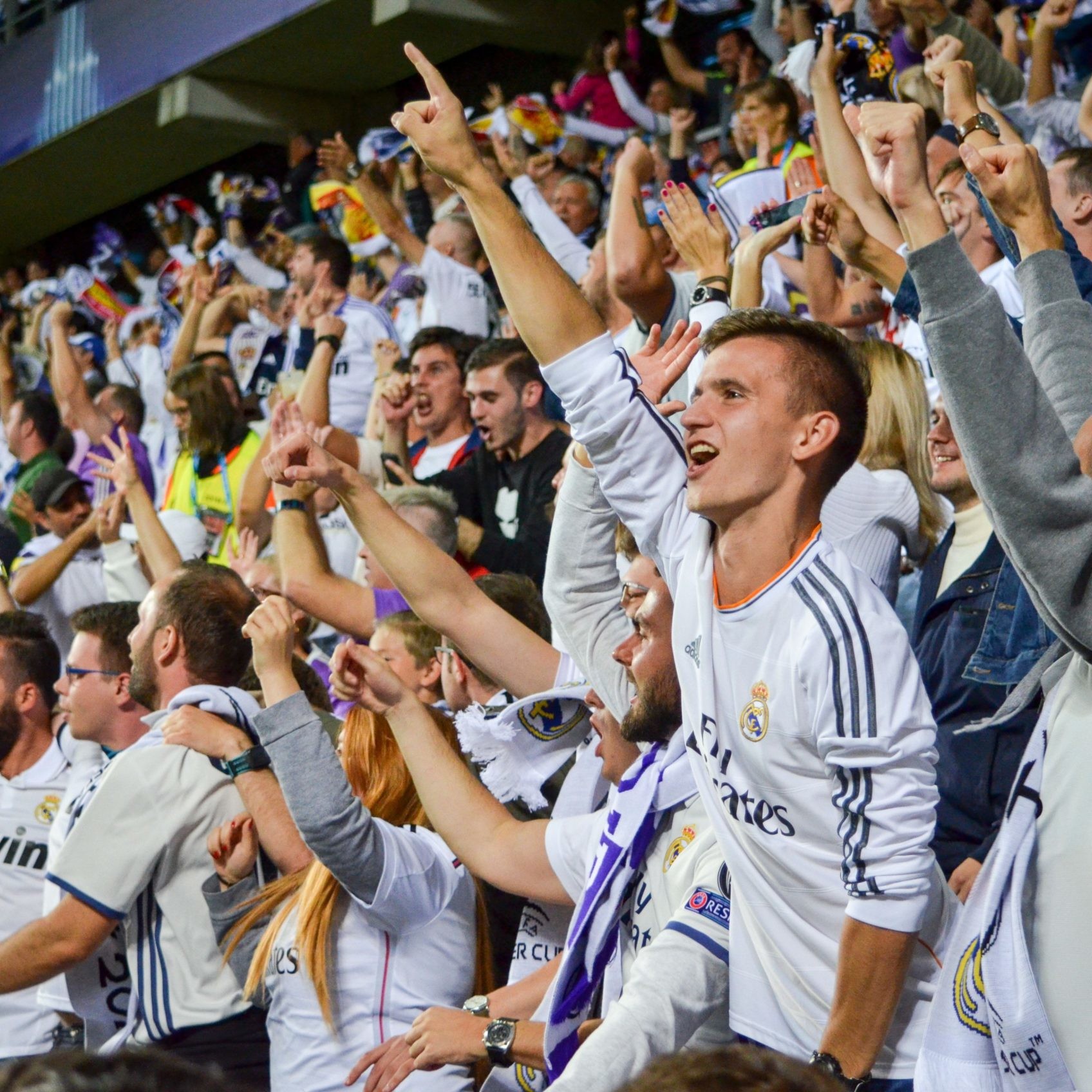 Image of football fans cheering during football match