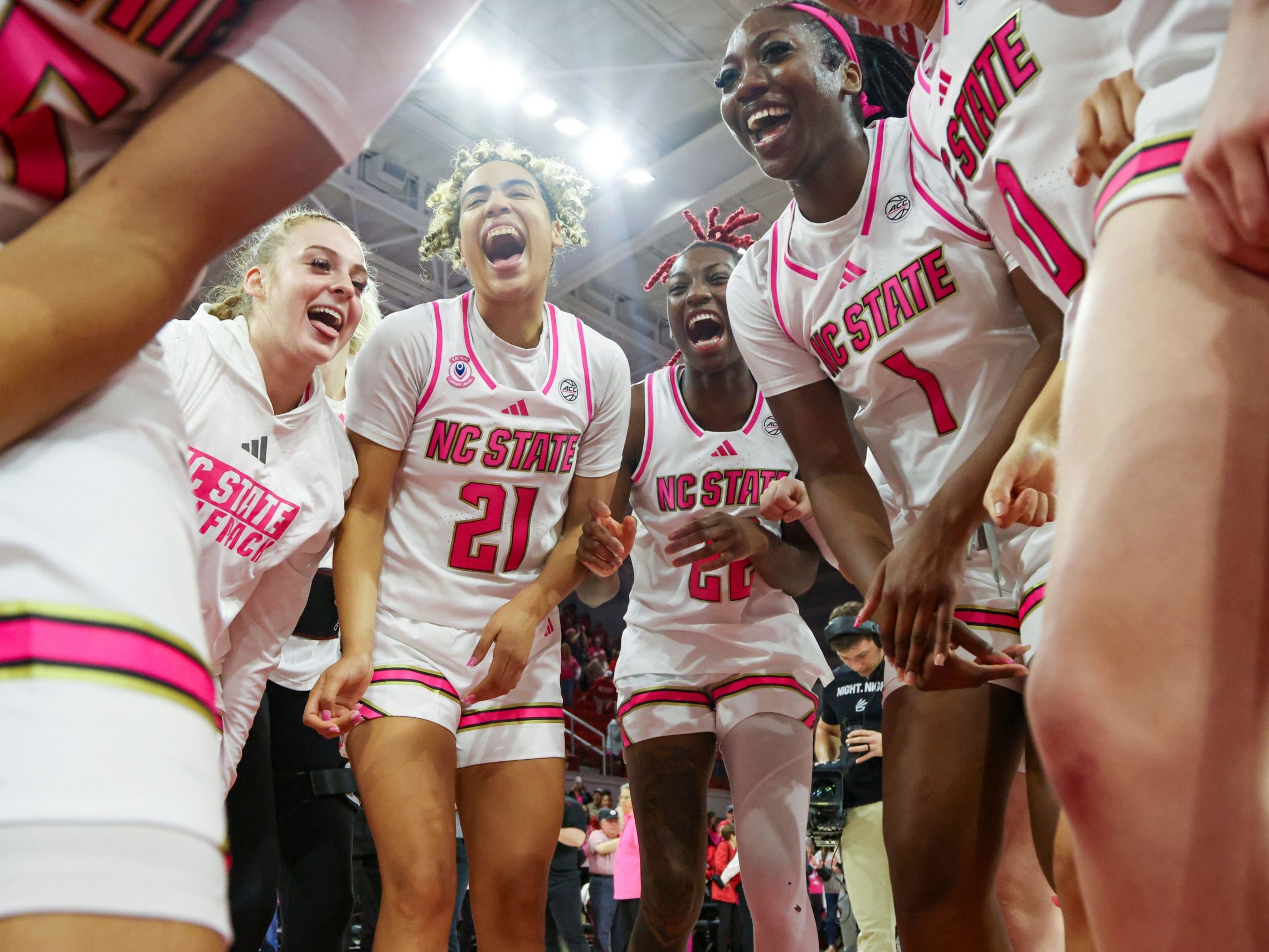 Action shot of female basketball players celebrating