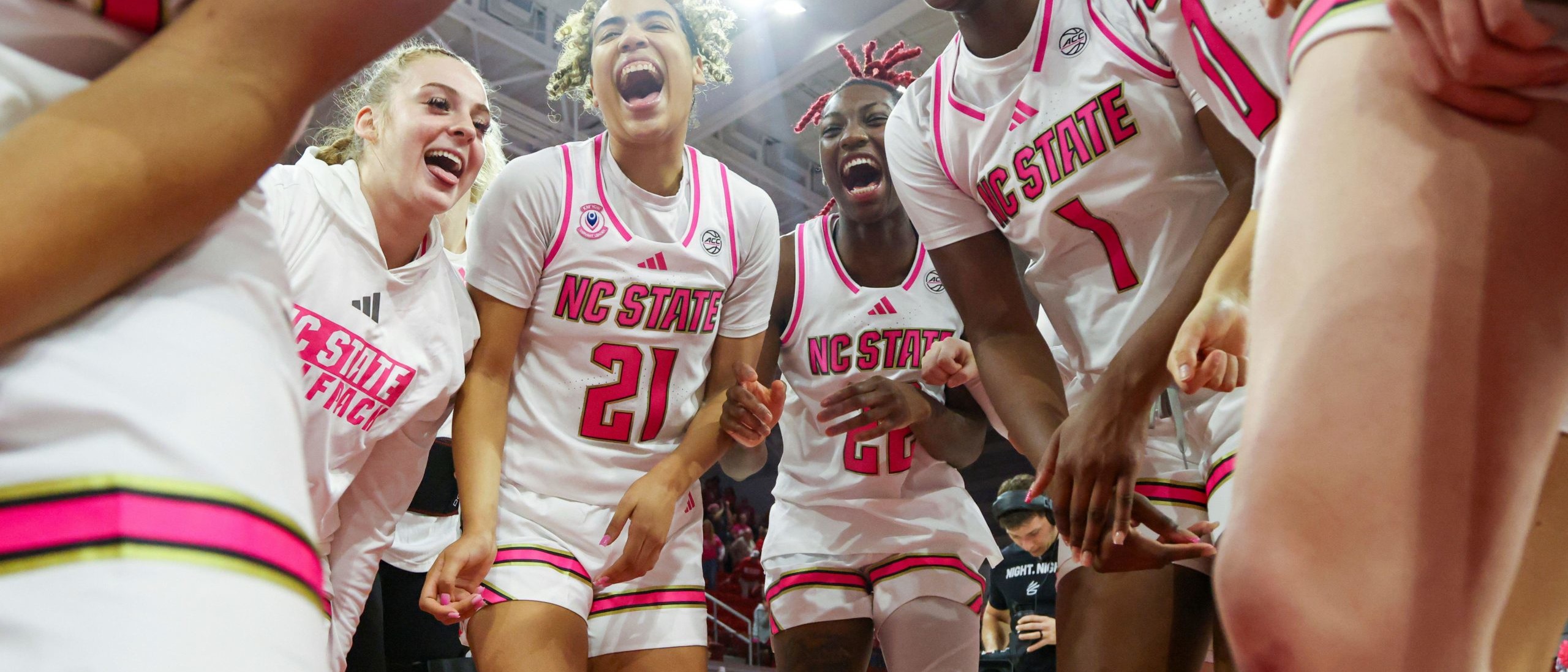 Action shot of female basketball players celebrating