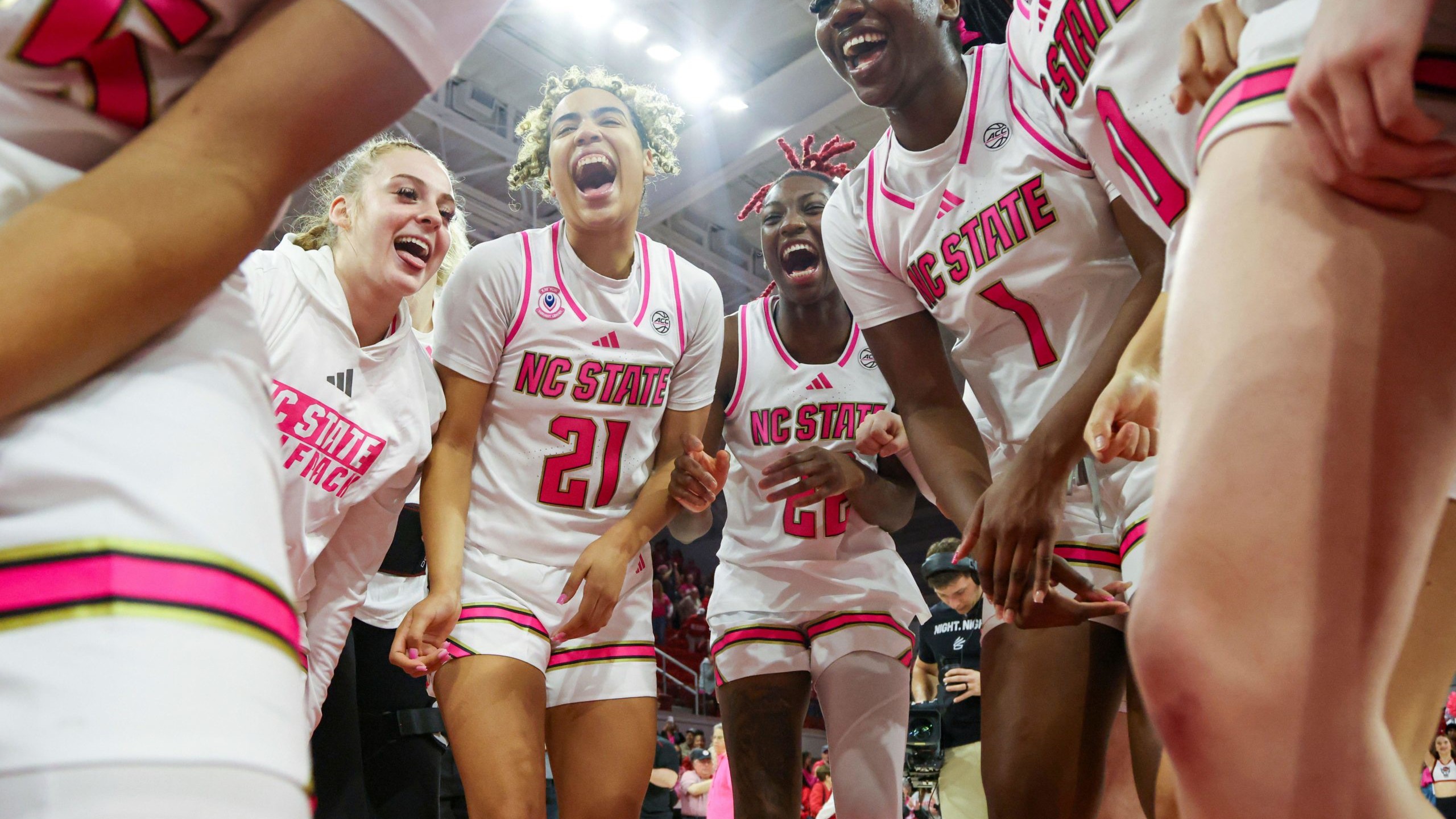 Action shot of female basketball players celebrating