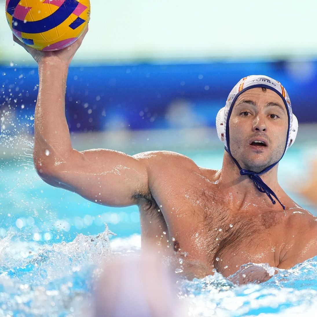 Water Polo athlete passing ball to teammate in pool