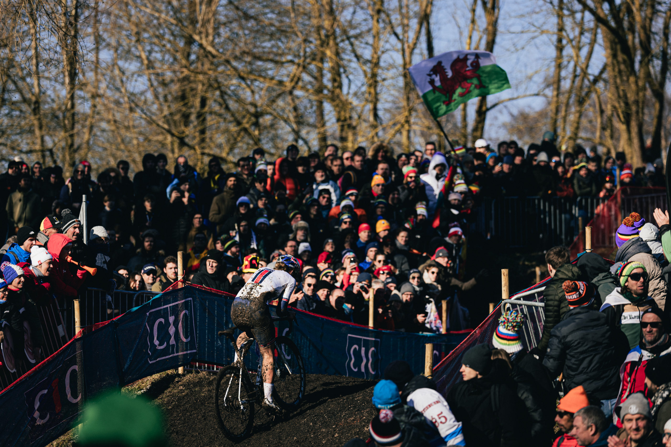 Mountain biker going through the course with fans surrounding him