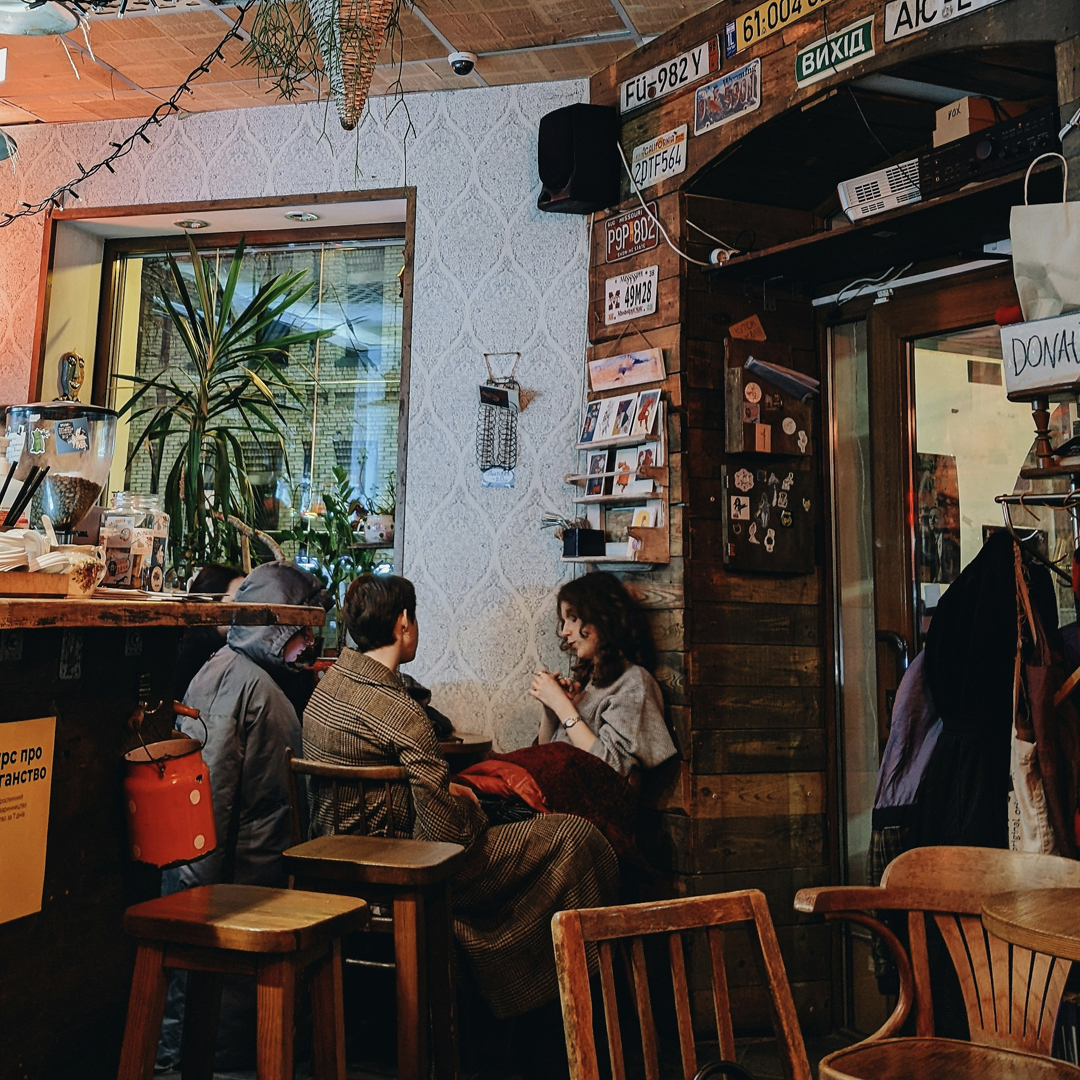Three people sitting in a restaurant talking