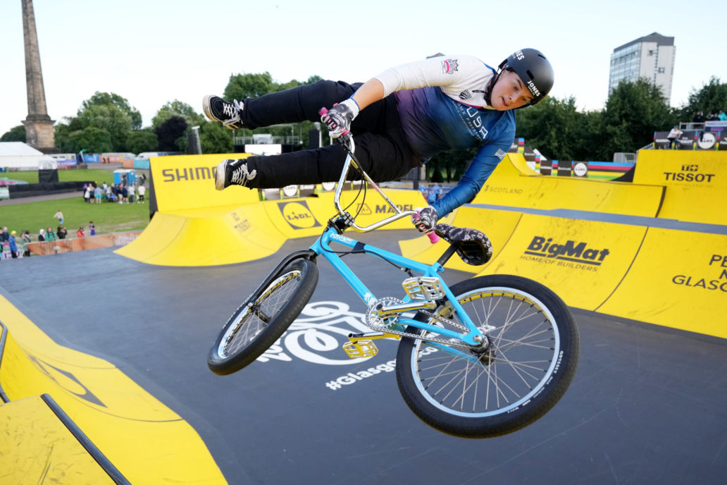 Female BMX athlete performing trick at BMX park
