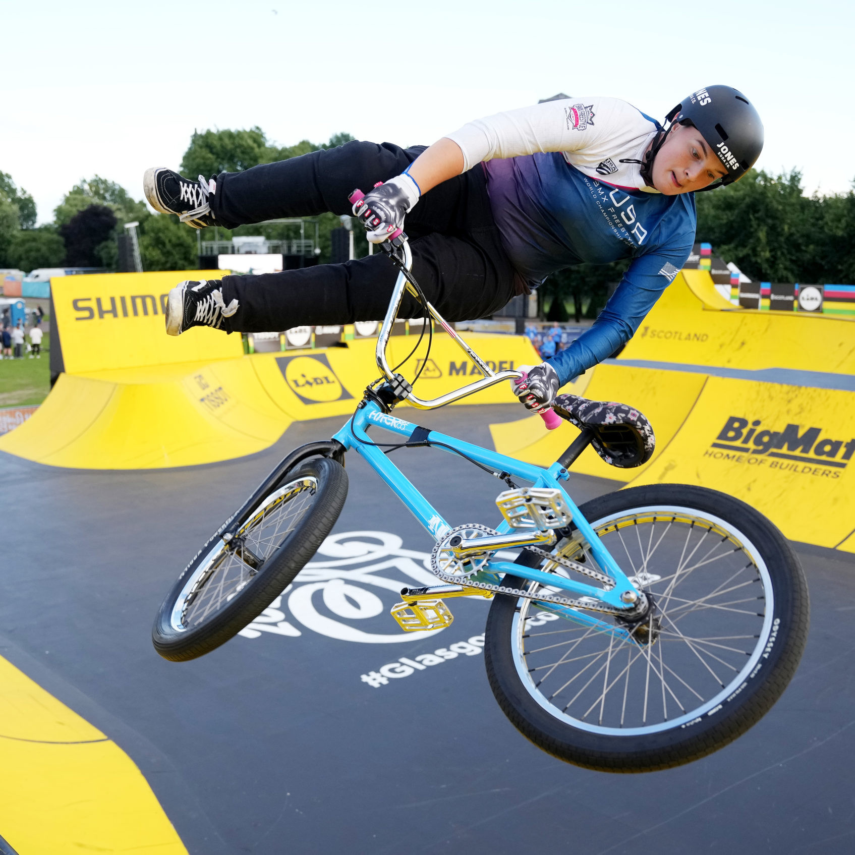 Female BMX athlete performing trick at BMX park