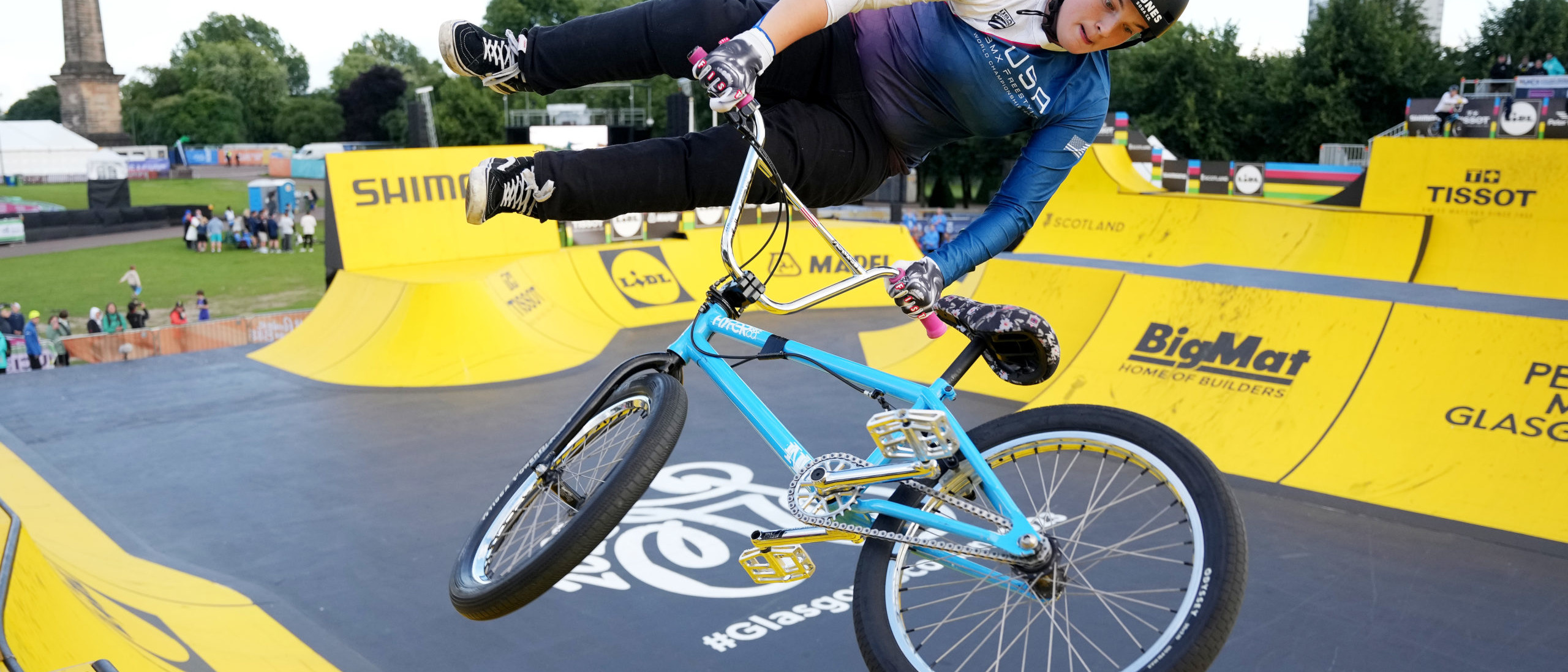 Female BMX athlete performing trick at BMX park