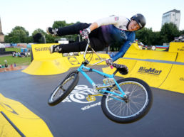 Female BMX athlete performing trick at BMX park