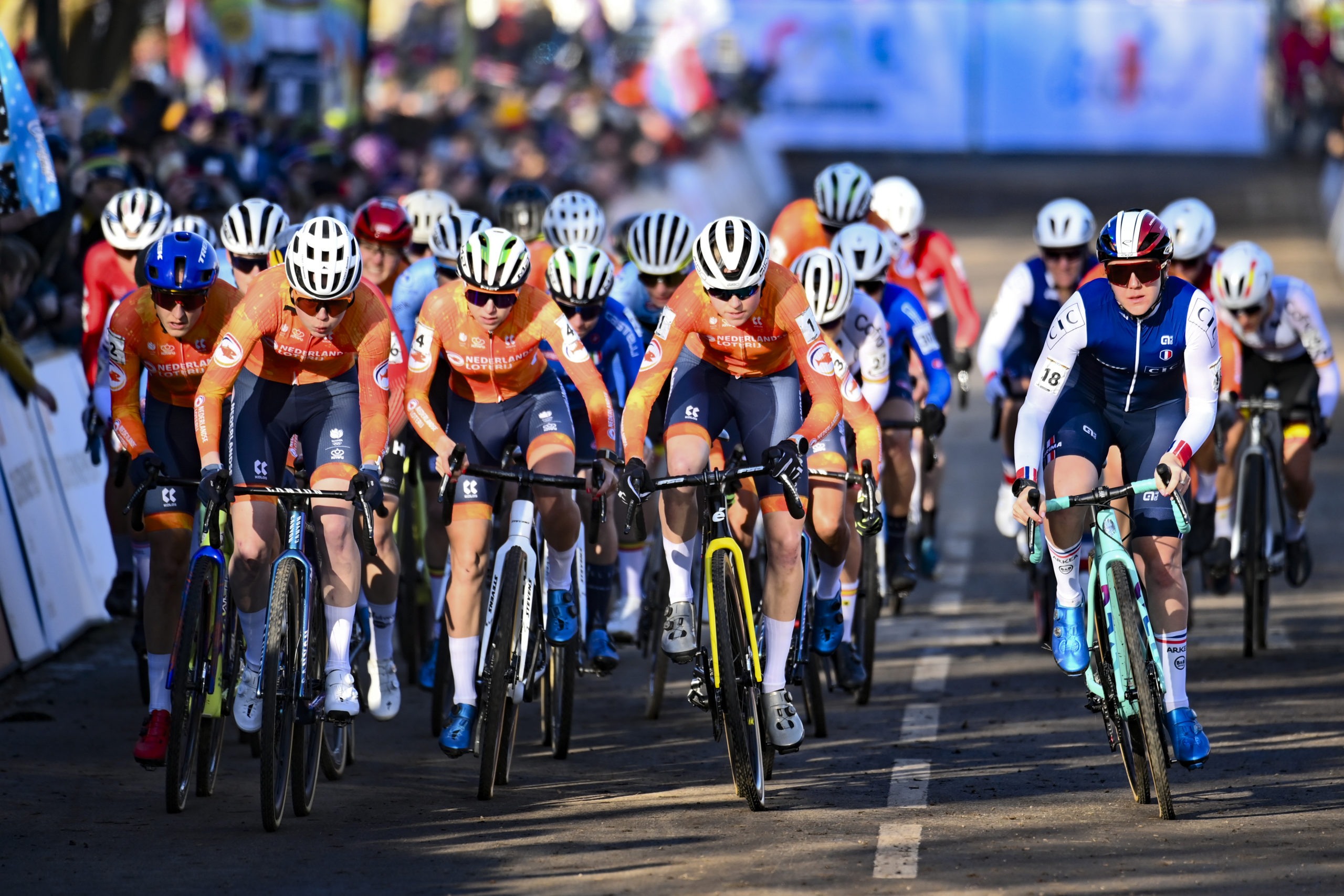 Group of cyclists sprinting towards the finish line