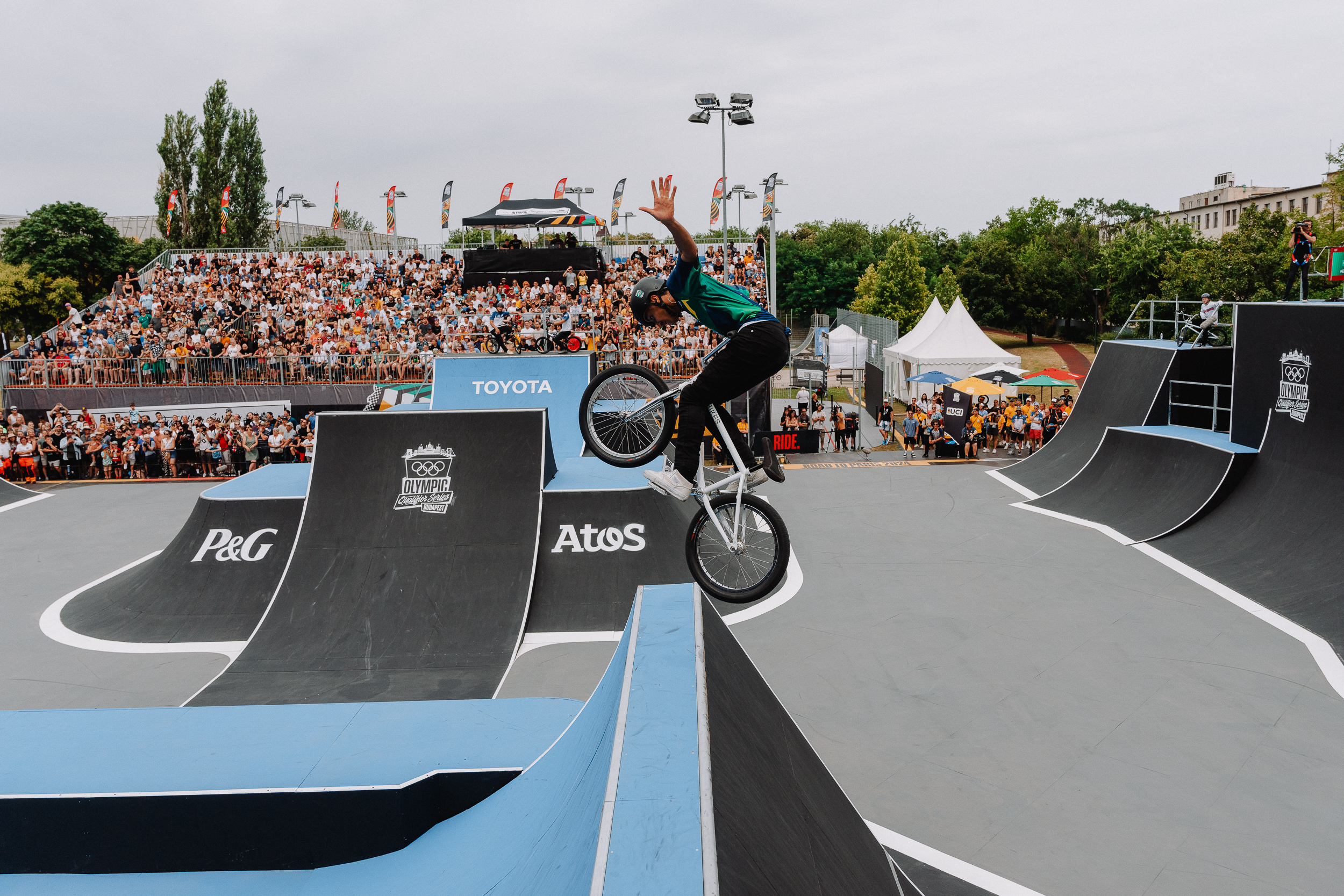 BMX rider performing trick with hands off the handlebars at a Budapest BMX park