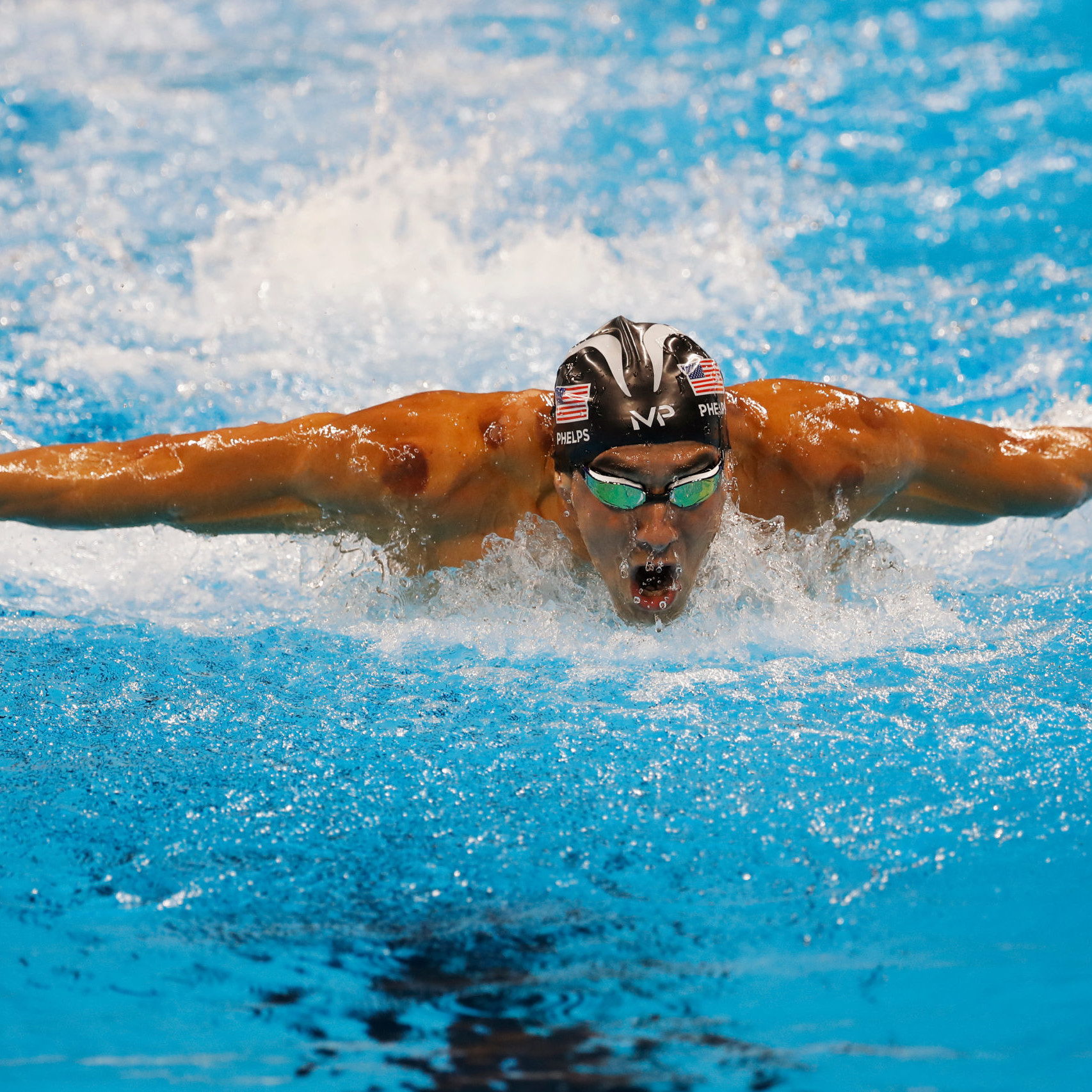 Michael Phelps mid swim performing butterfly