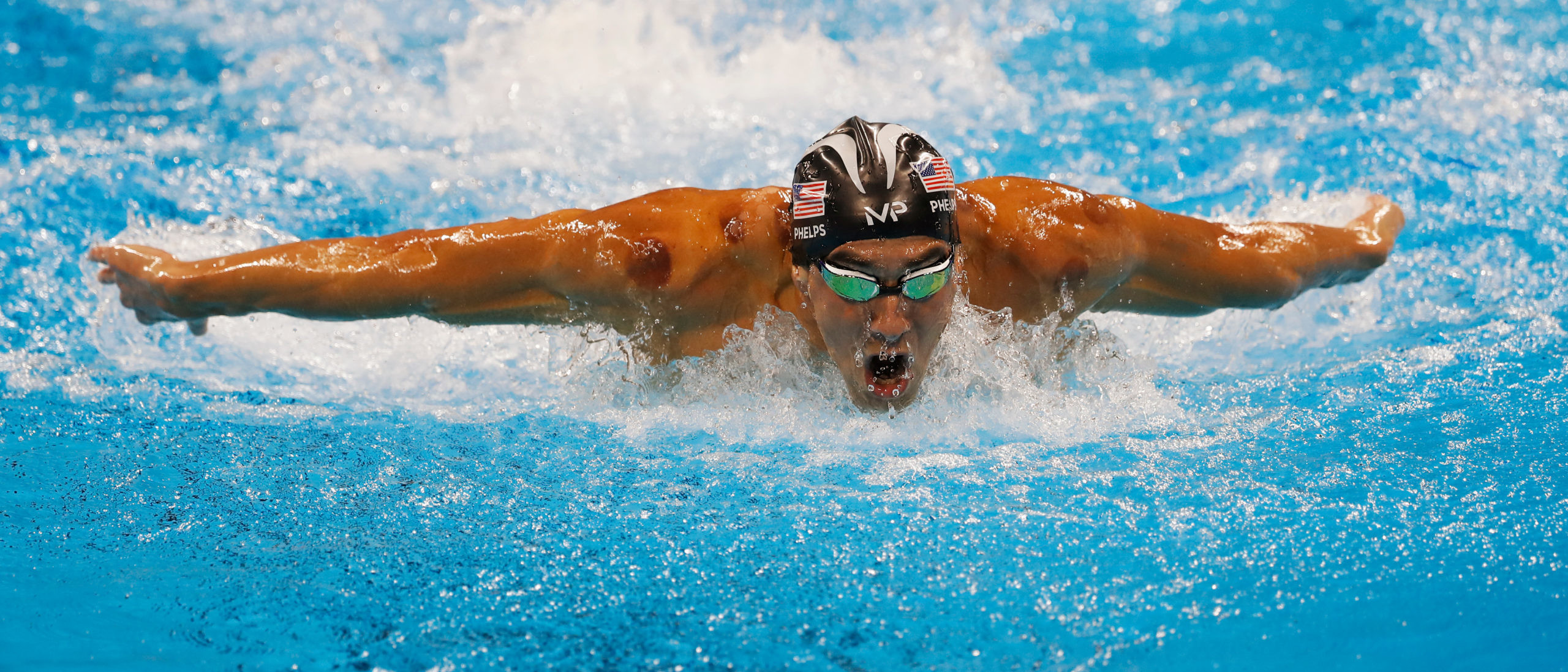 Michael Phelps mid swim performing butterfly