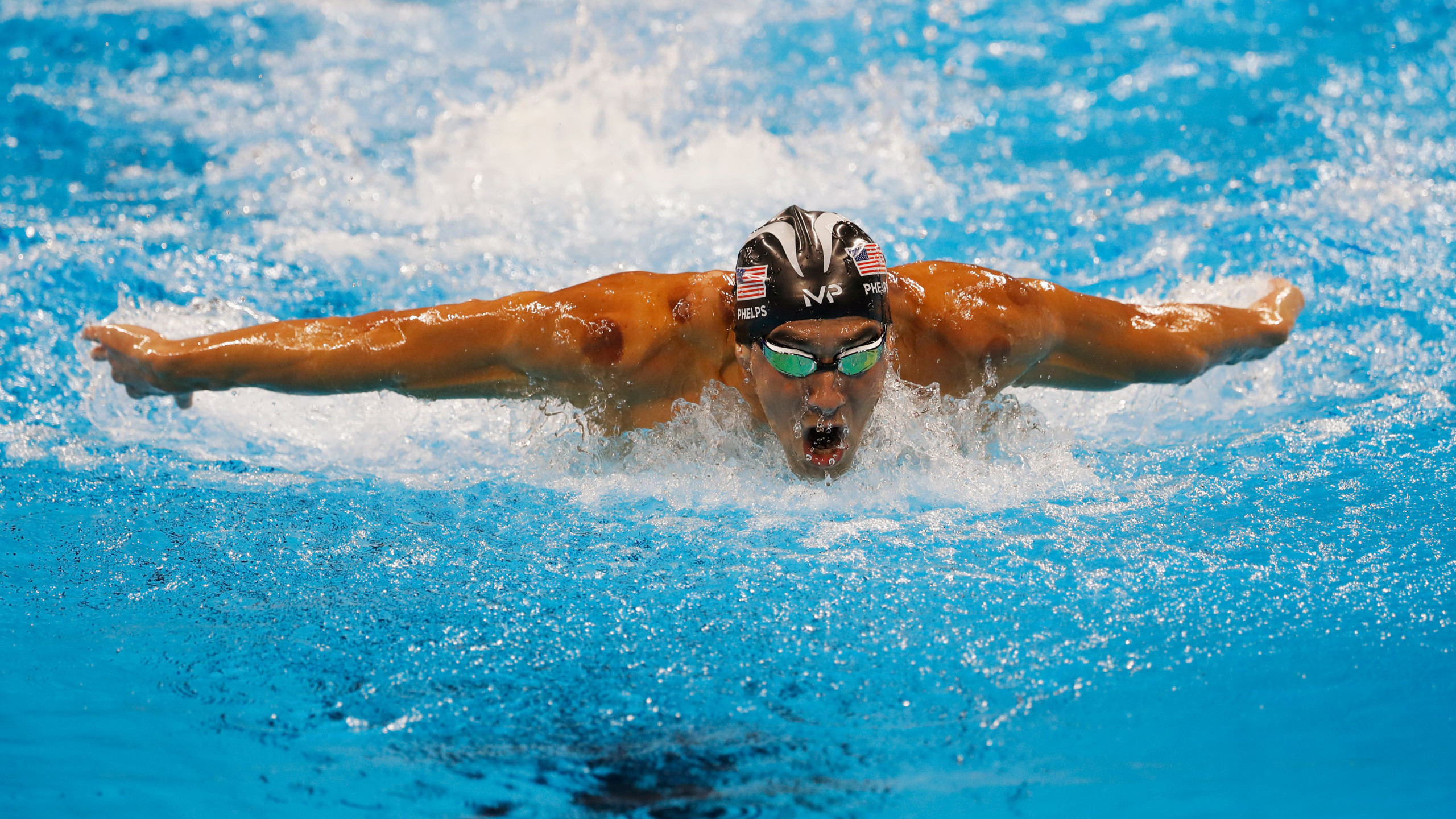 Michael Phelps mid swim performing butterfly