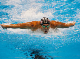 Michael Phelps mid swim performing butterfly