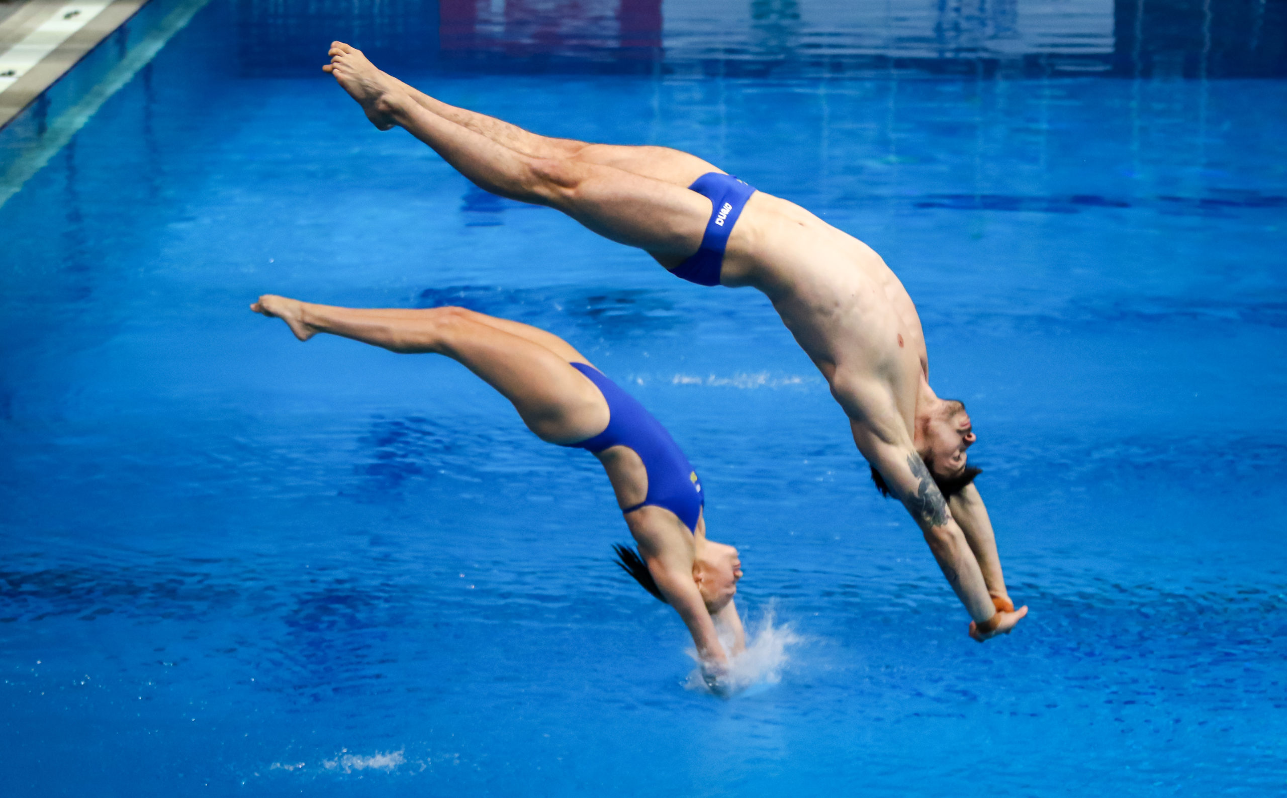 Male and Female divers about to enter the water