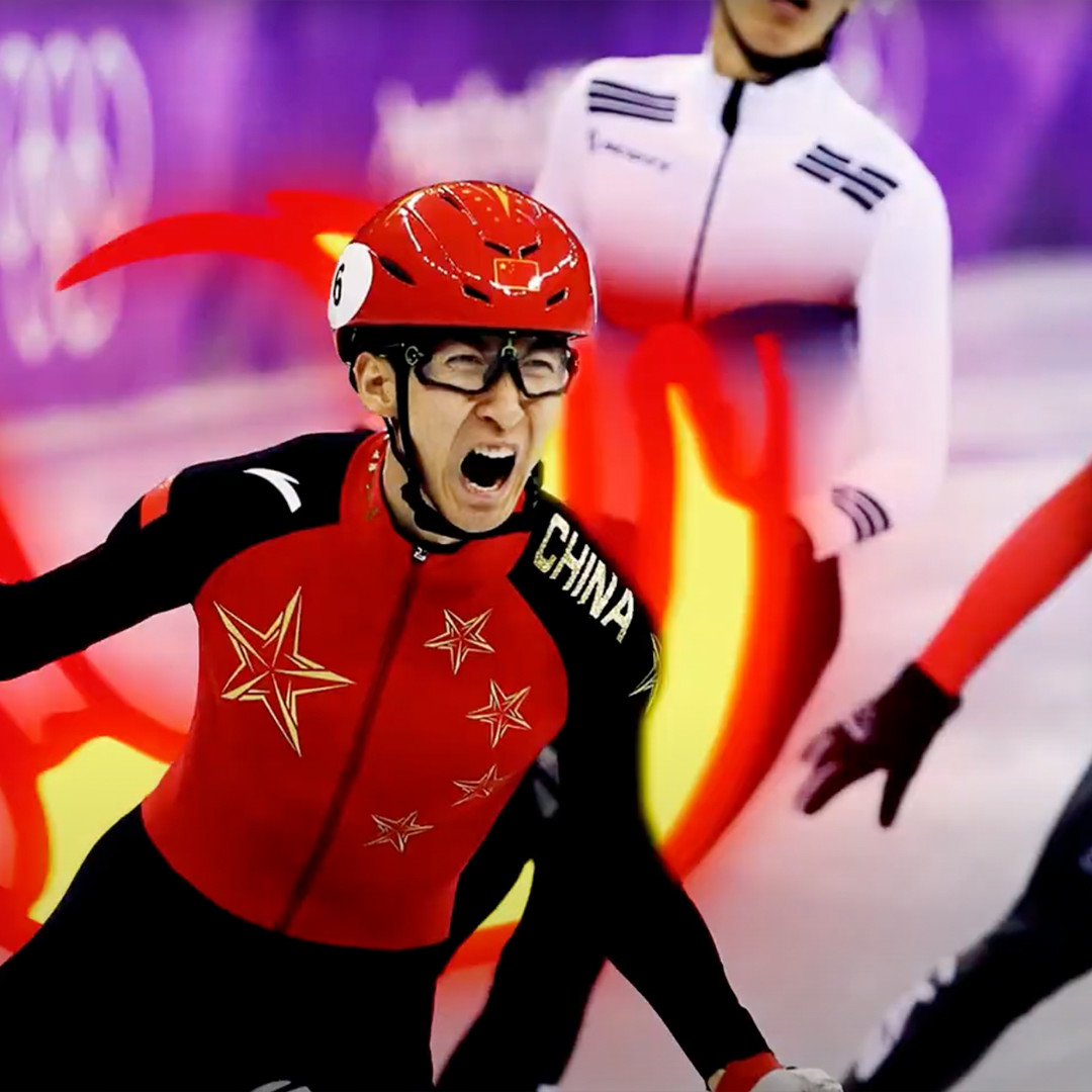 Chinese speed skater celebrating victory as he crosses the line