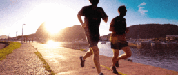 SportOnSocial Global Running Culture 2025 - Silhouette of two men running with the sun setting behind