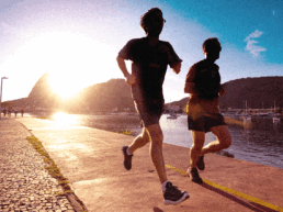 SportOnSocial Global Running Culture 2025 - Silhouette of two men running with the sun setting behind