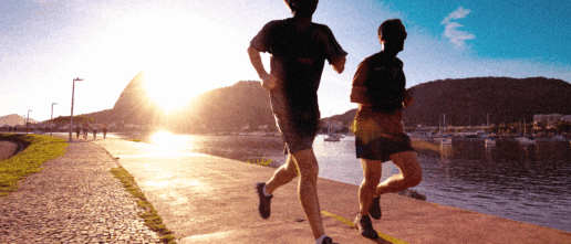 SportOnSocial Global Running Culture 2025 - Silhouette of two men running with the sun setting behind
