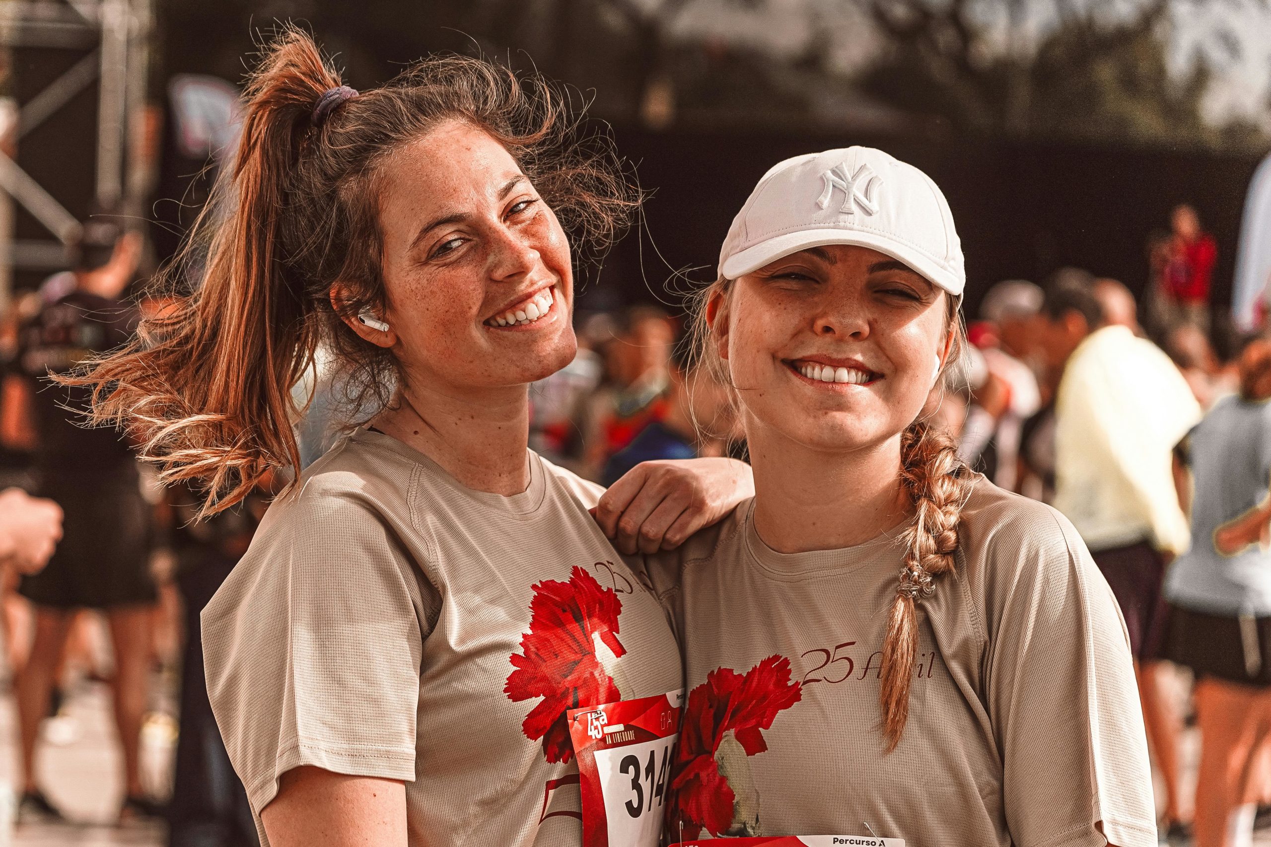 Two friends smiling at a running event - - SportOnSocial Global Running Culture 2025